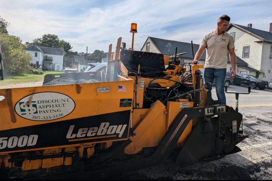 Owner on the company paver next to the Discount Asphalt Paving logo